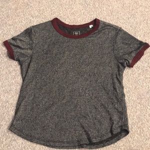 A dark grey, short sleeve tee shirt